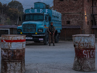 Indian soldiers stand alert while frisking vehicles and suspected persons in Baramulla, Jammu and Kashmir, India, on October 28, 2024. In th...