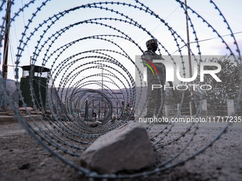 Indian soldiers stand alert while frisking vehicles and suspected persons in Baramulla, Jammu and Kashmir, India, on October 28, 2024. In th...