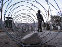 Indian soldiers stand alert while frisking vehicles and suspected persons in Baramulla, Jammu and Kashmir, India, on October 28, 2024. In th...