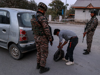 Indian soldiers stand alert while frisking vehicles and suspected persons in Baramulla, Jammu and Kashmir, India, on October 28, 2024. In th...