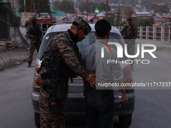 Indian soldiers stand alert while frisking vehicles and suspected persons in Baramulla, Jammu and Kashmir, India, on October 28, 2024. In th...