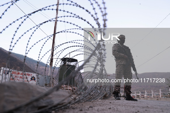 Indian soldiers stand alert while frisking vehicles and suspected persons in Baramulla, Jammu and Kashmir, India, on October 28, 2024. In th...