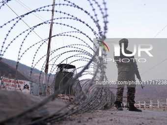 Indian soldiers stand alert while frisking vehicles and suspected persons in Baramulla, Jammu and Kashmir, India, on October 28, 2024. In th...