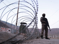 Indian soldiers stand alert while frisking vehicles and suspected persons in Baramulla, Jammu and Kashmir, India, on October 28, 2024. In th...