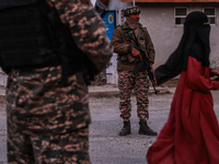 Indian soldiers stand alert while frisking vehicles and suspected persons in Baramulla, Jammu and Kashmir, India, on October 28, 2024. In th...