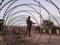 Indian soldiers stand alert while frisking vehicles and suspected persons in Baramulla, Jammu and Kashmir, India, on October 28, 2024. In th...