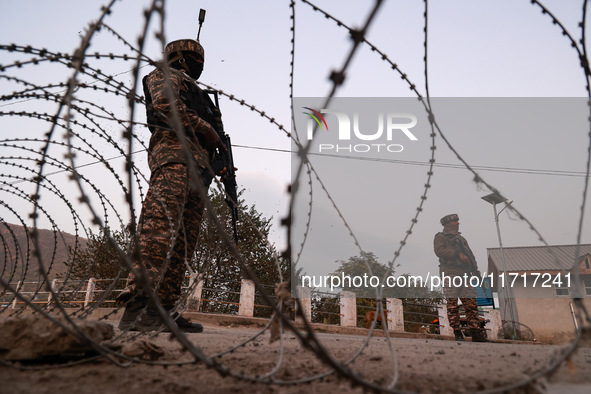 Indian soldiers stand alert while frisking vehicles and suspected persons in Baramulla, Jammu and Kashmir, India, on October 28, 2024. In th...