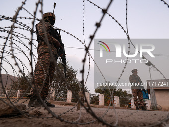 Indian soldiers stand alert while frisking vehicles and suspected persons in Baramulla, Jammu and Kashmir, India, on October 28, 2024. In th...