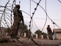 Indian soldiers stand alert while frisking vehicles and suspected persons in Baramulla, Jammu and Kashmir, India, on October 28, 2024. In th...