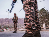 Indian soldiers stand alert while frisking vehicles and suspected persons in Baramulla, Jammu and Kashmir, India, on October 28, 2024. In th...