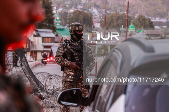 Indian soldiers stand alert while frisking vehicles and suspected persons in Baramulla, Jammu and Kashmir, India, on October 28, 2024. In th...