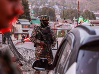 Indian soldiers stand alert while frisking vehicles and suspected persons in Baramulla, Jammu and Kashmir, India, on October 28, 2024. In th...