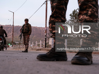 Indian soldiers stand alert while frisking vehicles and suspected persons in Baramulla, Jammu and Kashmir, India, on October 28, 2024. In th...