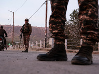 Indian soldiers stand alert while frisking vehicles and suspected persons in Baramulla, Jammu and Kashmir, India, on October 28, 2024. In th...