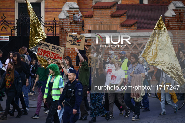 People attend a demonstration against the Polish government's plans to suspend the right to asylum for refugees illegally crossing the Polis...