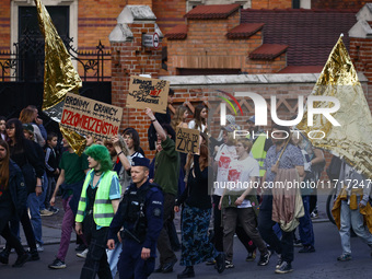 People attend a demonstration against the Polish government's plans to suspend the right to asylum for refugees illegally crossing the Polis...