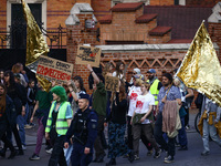 People attend a demonstration against the Polish government's plans to suspend the right to asylum for refugees illegally crossing the Polis...