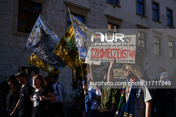 People attend a demonstration against the Polish government's plans to suspend the right to asylum for refugees illegally crossing the Polis...