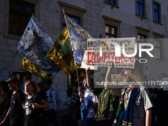 People attend a demonstration against the Polish government's plans to suspend the right to asylum for refugees illegally crossing the Polis...