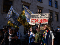 People attend a demonstration against the Polish government's plans to suspend the right to asylum for refugees illegally crossing the Polis...