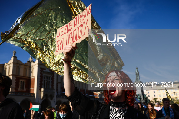 A person holds a banner reading 'Jesus Christ was a refugee' while attending a demonstration against the Polish government's plans to suspen...