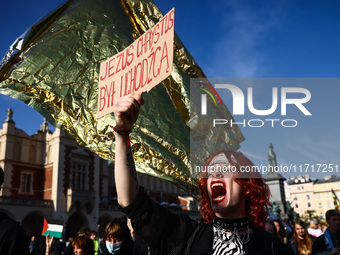 A person holds a banner reading 'Jesus Christ was a refugee' while attending a demonstration against the Polish government's plans to suspen...