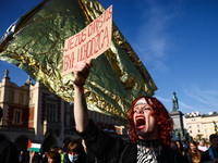 A person holds a banner reading 'Jesus Christ was a refugee' while attending a demonstration against the Polish government's plans to suspen...