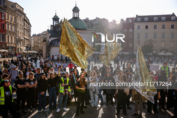 People hold emergency blankets used as flags while attending a demonstration against the Polish government's plans to suspend the right to a...