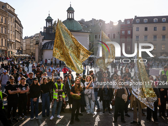 People hold emergency blankets used as flags while attending a demonstration against the Polish government's plans to suspend the right to a...