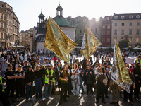 People hold emergency blankets used as flags while attending a demonstration against the Polish government's plans to suspend the right to a...