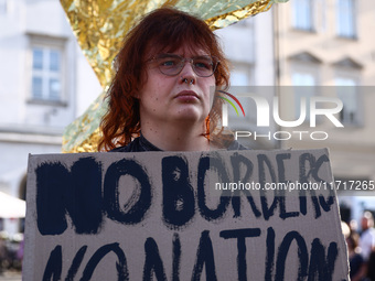 A person holds 'No borders, no nations' banner while attending a demonstration against the Polish government's plans to suspend the right to...