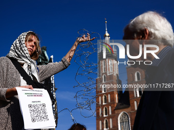 A woman holds barbed wire while attending a demonstration against the Polish government's plans to suspend the right to asylum for refugees...