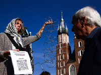 A woman holds barbed wire while attending a demonstration against the Polish government's plans to suspend the right to asylum for refugees...