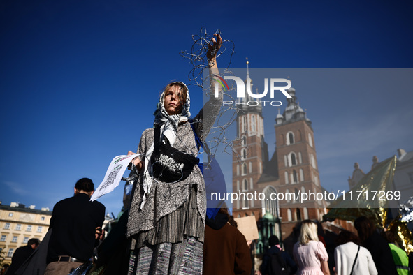 A woman holds barbed wire while attending a demonstration against the Polish government's plans to suspend the right to asylum for refugees...