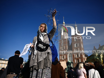 A woman holds barbed wire while attending a demonstration against the Polish government's plans to suspend the right to asylum for refugees...