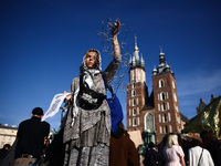 A woman holds barbed wire while attending a demonstration against the Polish government's plans to suspend the right to asylum for refugees...