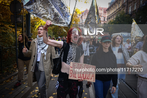 A person holds a banner reading 'Jesus Christ was a refugee' while attending a demonstration against the Polish government's plans to suspen...