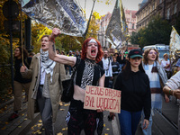 A person holds a banner reading 'Jesus Christ was a refugee' while attending a demonstration against the Polish government's plans to suspen...