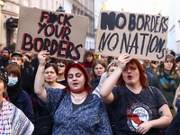 People attend a demonstration against the Polish government's plans to suspend the right to asylum for refugees illegally crossing the Polis...