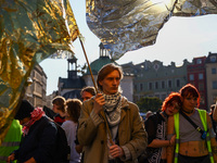 People hold emergency blankets used as flags while attending a demonstration against the Polish government's plans to suspend the right to a...