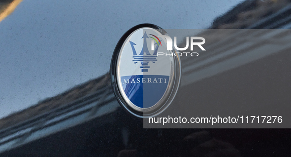 An image captures the Maserati trident logo on the hood of a car parked in the center of Bari, Italy, on October 24, 2024. The photo highlig...