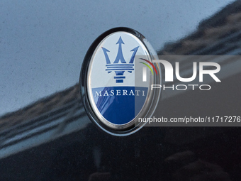 An image captures the Maserati trident logo on the hood of a car parked in the center of Bari, Italy, on October 24, 2024. The photo highlig...