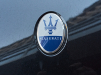 An image captures the Maserati trident logo on the hood of a car parked in the center of Bari, Italy, on October 24, 2024. The photo highlig...