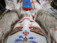 A cat rests next to the feet of an idol of the Hindu goddess Kali inside a ''pandal'' (a temporary platform), a decorated structure, ahead o...