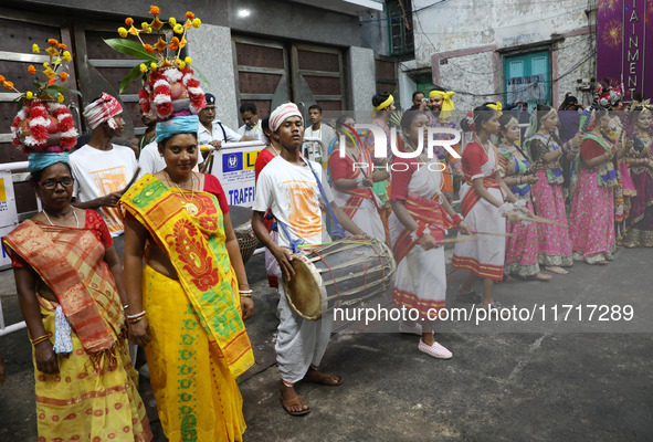 Artists perform during an inauguration program next to a ''pandal'' (a temporary platform), a decorated structure, next to an idol of the Hi...