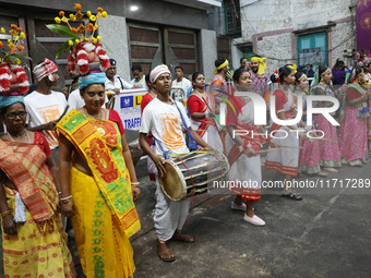 Artists perform during an inauguration program next to a ''pandal'' (a temporary platform), a decorated structure, next to an idol of the Hi...