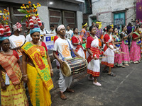 Artists perform during an inauguration program next to a ''pandal'' (a temporary platform), a decorated structure, next to an idol of the Hi...