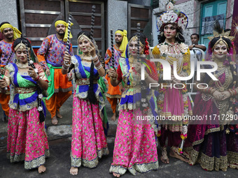 Artists perform during an inauguration program next to a ''pandal'' (a temporary platform), a decorated structure, next to an idol of the Hi...