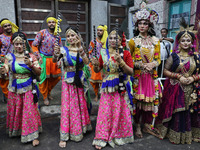 Artists perform during an inauguration program next to a ''pandal'' (a temporary platform), a decorated structure, next to an idol of the Hi...