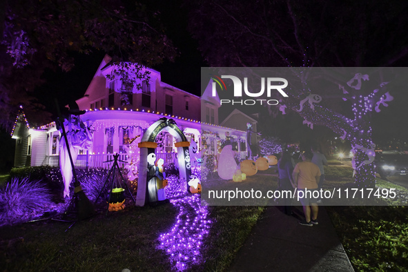 In the backyards of houses in the Celebration, FL, region, people create scary scenes with inflatable and luminous dolls for Halloween on Su...